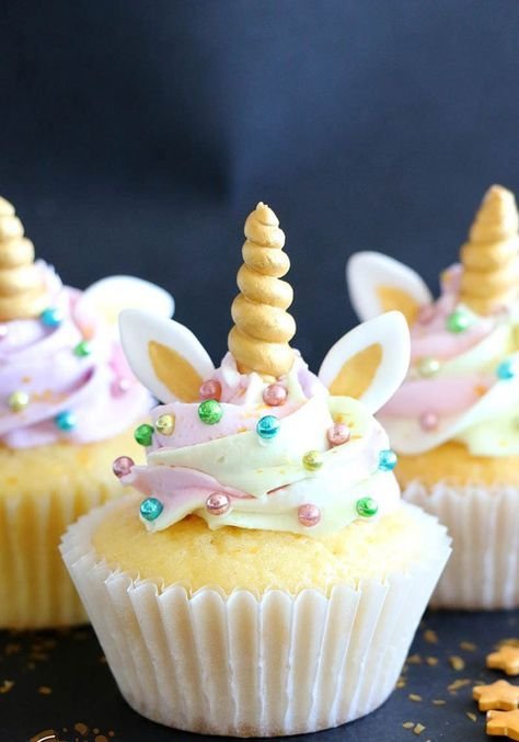 cupcakes has this multicolored frosting, ears and horn of unicorns