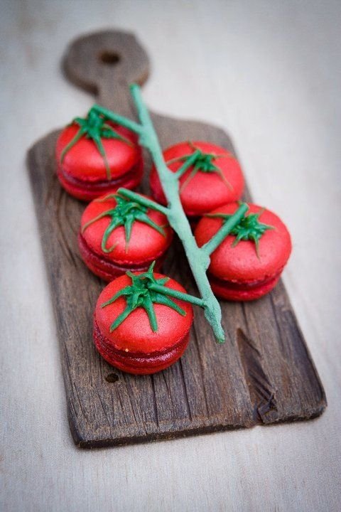 macaroons shaped tomatoes on a green branch