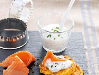 Small sweet potato blinis with herbs and almonds, smoked trout