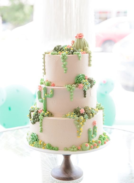 white tier cake with climbing and fat plants in butter cream