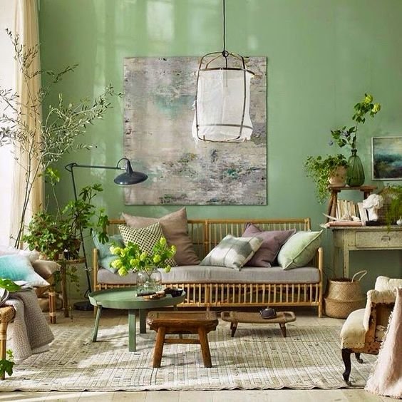green spring walls in a living room, wicker furniture