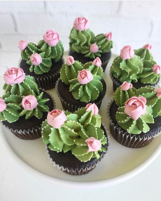 cupcakes decorated with green cactus with pink flowers
