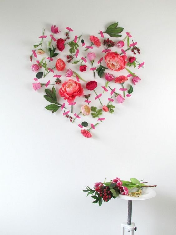 heart in artificial flowers on the wall