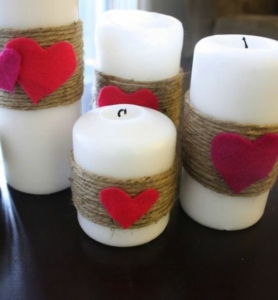candle surrounded by string and felt heart
