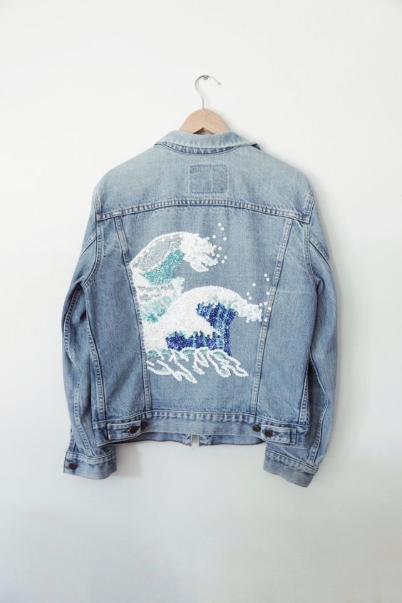 a work of the artist okusai reproduced on the back of a jean jacket