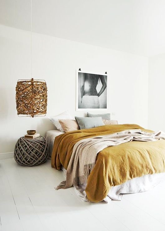 with mustard bed linen and straw lampshade