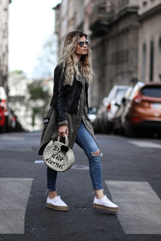 with a long military khaki jacket and jeans with hole