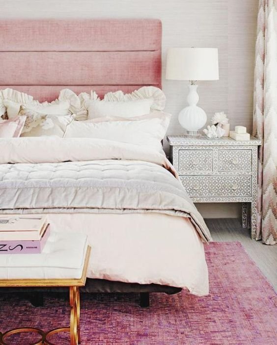 with a pink headboard and pink baby sheets