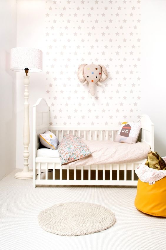 a white wallpaper with gray stars in the nursery