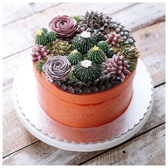 orange round cake with cactus in butter cream